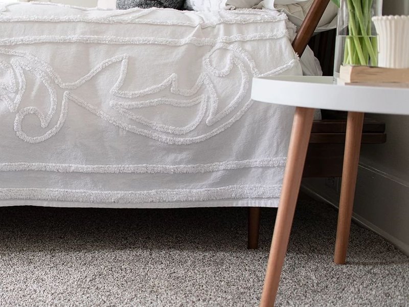 bed and coffee table on carpet - Andersons New Carpet Design in Fridley